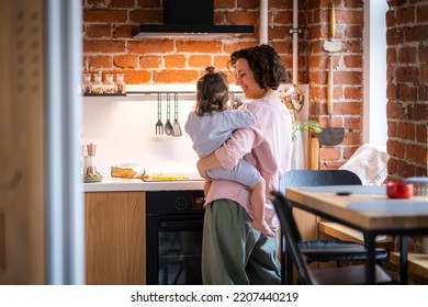 Young Mother With Baby Girl On Her Hands Cooking Together At Kitchen At Home, Domestic Chores At Maternity Leave.