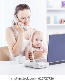  Young Mother And Baby Using Laptop To Communicate With Grandma Via Skype,