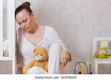 Young mother between 30 and 40 years old is experiencing postnatal depression.