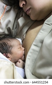young mother breast feeding her newborn baby