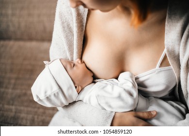 Young mother breastfeeding baby