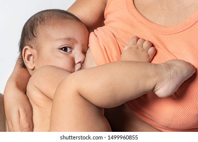 Young mother breastfeeding her newborn.
Crucial and natural feeding phase of a newborn