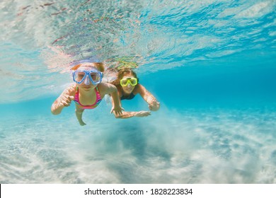 Young Mother With Child In Snorkeling Mask Dive In Sea Lagoon To Explore Underwater World. Family Travel Lifestyle In Summer Adventure Camp. Swimming Activities On Beach Vacation With Kids.