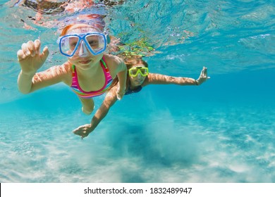 Young Mother With Child In Snorkeling Mask Dive In Coral Reef Sea Lagoon To Explore Underwater World. Family Travel Lifestyle In Summer Adventure Camp. Swimming Activities On Beach Vacation With Kids.