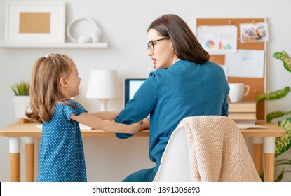 Young mother with child working on the computer. Family at home. Remote work.  - Shutterstock ID 1891306693