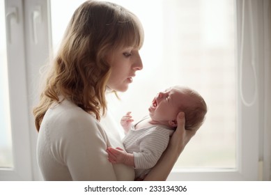 young mother with crying baby