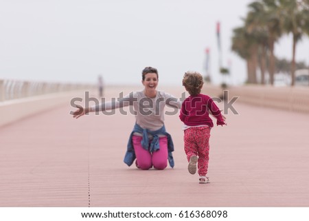 Similar – Little girl running with women on beach