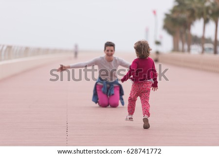 Similar – Little girl running with women on beach