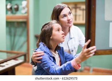 Young Mother And Daughter Enjoying Medieval Expositions In A Museum. Focus On Child 