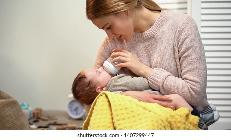 Young Mother Feeding Infant From Bottle, Problems With Breast Feeding, Mastitis