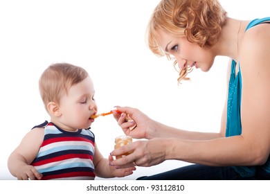 Young mother feeds  her baby on a white background. Happy family. - Shutterstock ID 93112810