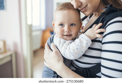 Young mother having her cute little daughter in baby carrier - Shutterstock ID 275130680