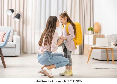 Young Mother Helping Her Daughter Get Ready For School