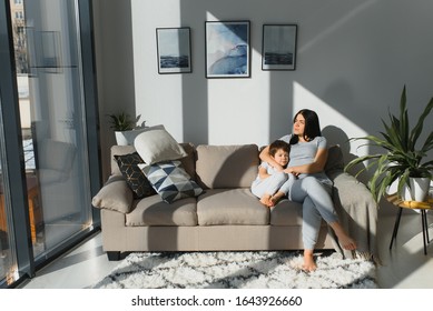 Young mother with her 4 years old little son dressed in pajamas are relaxing and playing in the bed at the weekend together, lazy morning, warm and cozy scene. - Shutterstock ID 1643926660