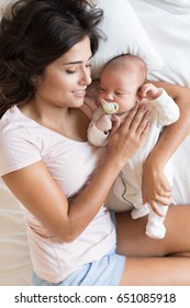 Young mother with her baby in bed - Shutterstock ID 651085918