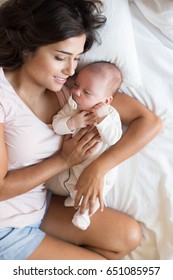 Young mother with her baby in bed - Shutterstock ID 651085957