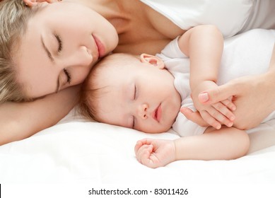 Young Mother And Her Baby, Sleeping In Bed