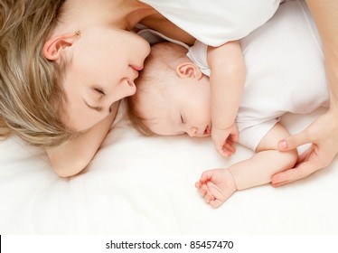 Young Mother And Her Baby, Sleeping In Bed