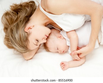 Young Mother And Her Baby, Sleeping In Bed