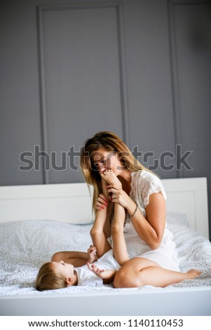 Similar – Baby sleeping on a blanket while her mother looks