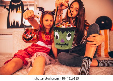 Young Mother And Her Daughter Enjoying Halloween Party. Focus On Frankenstein.