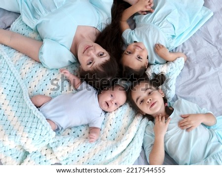 Similar – Top view of happy children having breakfast in the bed with their mother in a relaxed morning