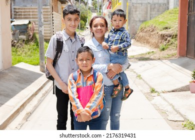 Young Mother With Her Happy Children Ready For Her To Go To School-Hispanic Family Outside Her House In Rural Area-Back To School In Latin America