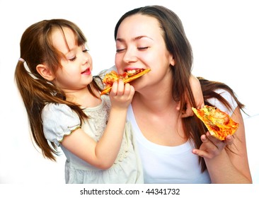 young mother and her little daughter eating pizza and having fun - Powered by Shutterstock