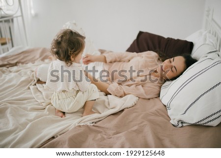 Similar – mother and child son sleeping together in bed