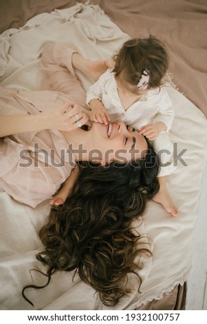 Similar – mother and child son sleeping together in bed