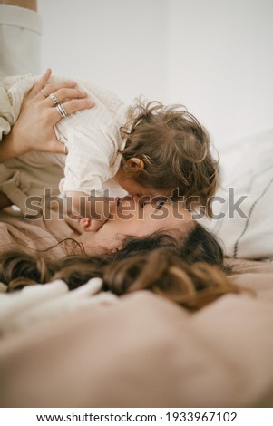 Similar – Image, Stock Photo Relaxed mother and sons embracing lying in the bed
