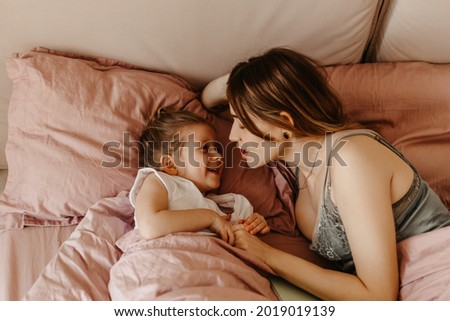 Similar – mother and child son sleeping together in bed