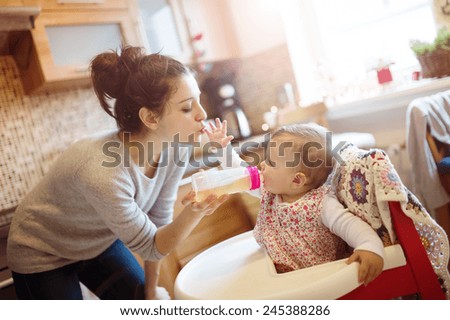 Similar – Image, Stock Photo Mother bottle feeding baby at home