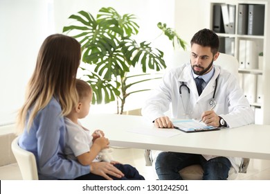 Young mother with her little son visiting doctor in clinic - Shutterstock ID 1301242501