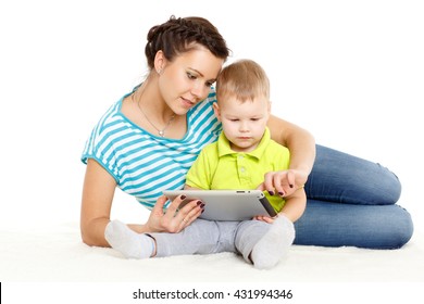 Young mother and her little son with computer tablet sit on a white background. Happy family.