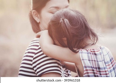 Young Mother Holding Her Crying Baby Girl