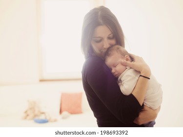 Young Mother Is Holding Her Little Baby