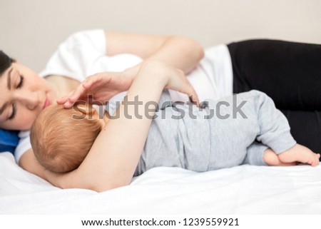 Similar – Baby asleep while parents caress