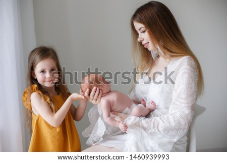 Young mother holding her newborn child. Mom nursing baby. Woman and new born boy relax. Nursery interior. Mother breast feeding baby. Family at home. Portrait of happy mother and baby. daughter, girl