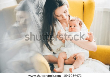 Similar – Image, Stock Photo Mother hugging her baby in front of fireplace