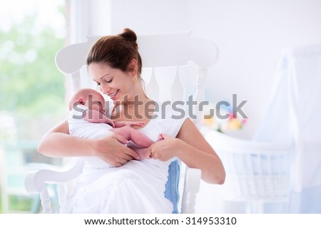 Стоковая фотография «Young Mother Holding Her <b>Newborn Child</b> ...