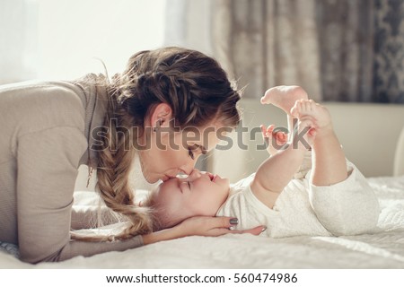 Similar – Image, Stock Photo Mother breast feeding and hugging her baby boy outdoors.