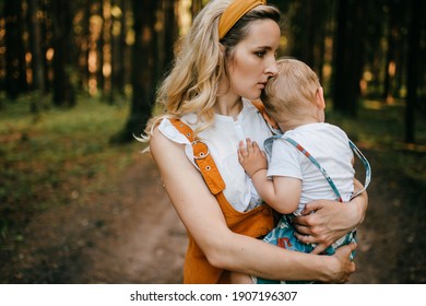 Young Mother Holding Her Son In The Forest