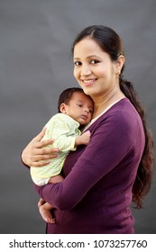 Young Mother Holding Newborn Baby