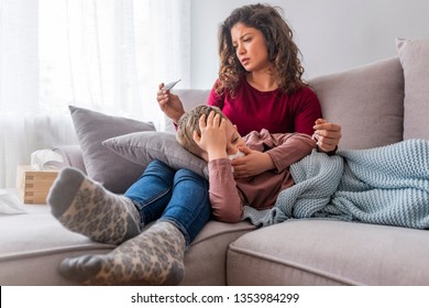 Young Mother Holding Sick Son Child On Hands, Lying On Knees, Touching Head Measuring Temperature, Cold Or Flu, Fever Of Illness, Looking On Thermometer, Cough And Throat Pain, Small Kid, Mother Care