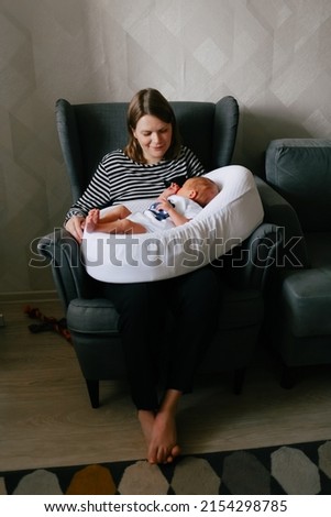 Similar – Image, Stock Photo Mother giving bottle to her newborn