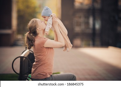 Young Mother With Infant Baby Outdoors