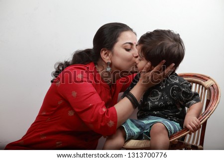 Young mother kisses her little boy