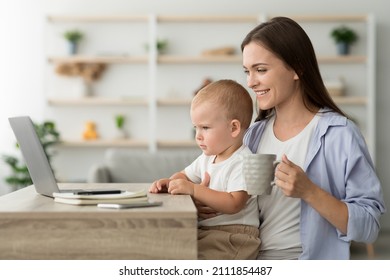 Young Mother With Little Baby Drinking Coffee And Using Laptop At Home, Happy Millennial Woman With Infant Son On Her Arms Relaxing With Computer, Having Break In Freelance Work, Side View