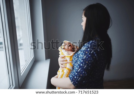 Similar – Image, Stock Photo Mother hugging her baby in front of fireplace